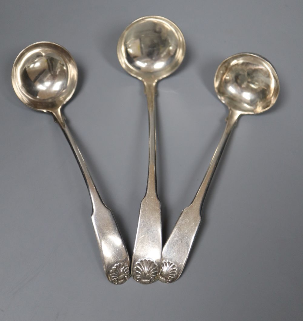 Three Scottish silver fiddle and shell pattern cream ladles, including a pair by John Zeigler, Edinburgh 1811.